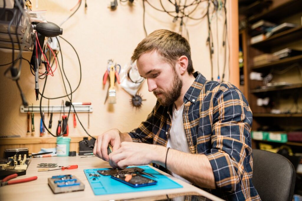 professional-repairman-bending-over-broken-smartphone-and-fixing-tiny-details.jpg